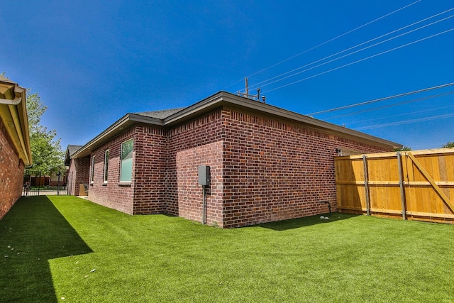 view of side of home with a lawn