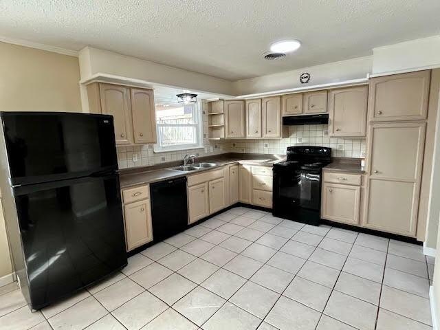 kitchen featuring sink, light tile patterned floors, backsplash, black appliances, and light brown cabinets