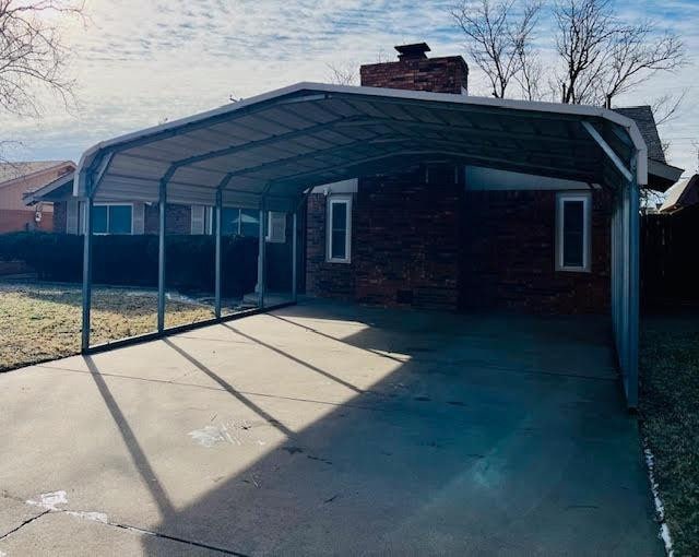 view of parking / parking lot featuring a carport