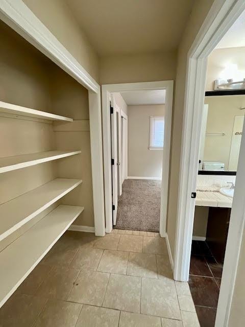 corridor featuring tile patterned flooring