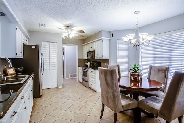 dining room featuring a healthy amount of sunlight, sink, a textured ceiling, and light tile patterned flooring