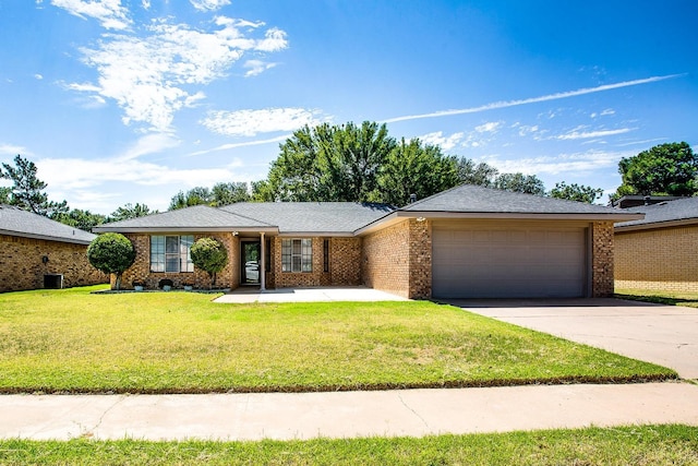 ranch-style home featuring a garage and a front yard