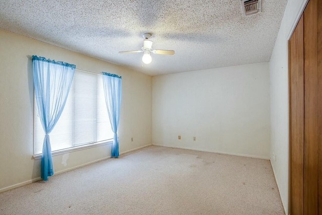 8206 Louisville Ave, Lubbock, TX 79423 - spare room featuring light carpet, a ceiling fan, and a textured ceiling