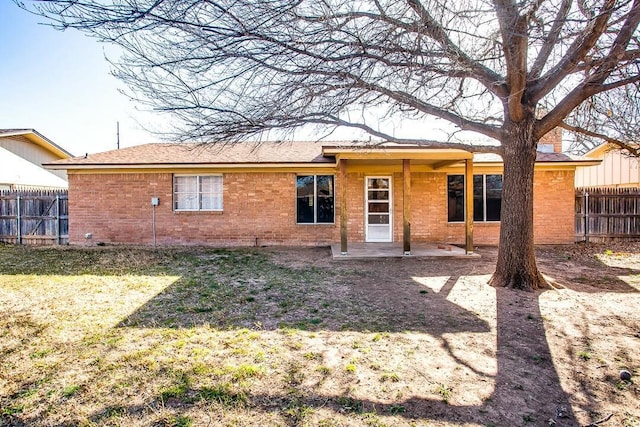 8206 Louisville Ave, Lubbock, TX 79423 - rear view of property with brick siding and a patio area