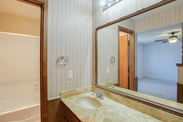 8206 Louisville Ave, Lubbock, TX 79423 - bathroom featuring vanity, wallpapered walls, a ceiling fan, and bathing tub / shower combination