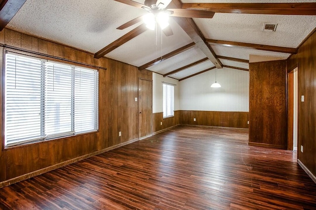 8206 Louisville Ave, Lubbock, TX 79423 - empty room featuring wood walls, hardwood / wood-style floors, a ceiling fan, and a textured ceiling