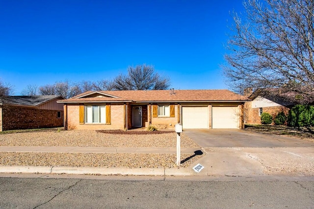 8206 Louisville Ave, Lubbock, TX 79423 - ranch-style home with a garage, concrete driveway, and brick siding