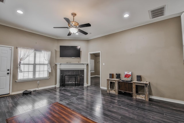 unfurnished living room with a fireplace, visible vents, baseboards, dark wood-style floors, and crown molding