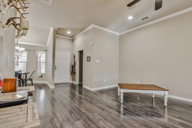 foyer entrance with ornamental molding, dark hardwood / wood-style floors, and ceiling fan with notable chandelier