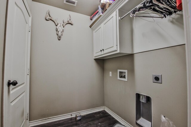 washroom featuring cabinets, hookup for a washing machine, dark hardwood / wood-style floors, and electric dryer hookup