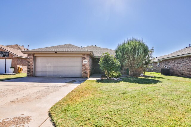 view of front facade featuring an attached garage, cooling unit, brick siding, driveway, and a front yard