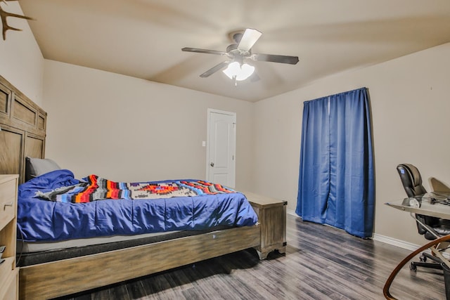 bedroom with ceiling fan, baseboards, and wood finished floors