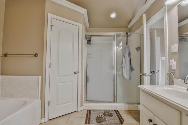 bathroom featuring tile patterned flooring, vanity, a washtub, and crown molding