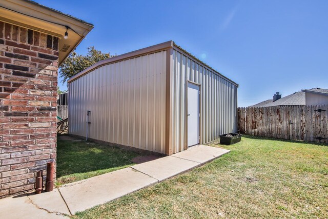 view of outbuilding featuring a yard