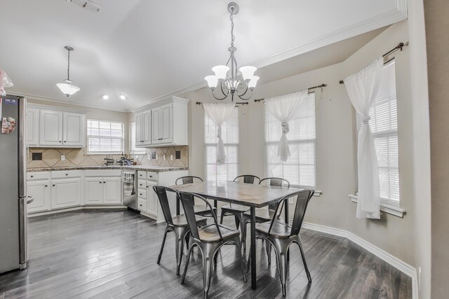 dining area with crown molding, plenty of natural light, and dark hardwood / wood-style floors