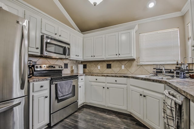 kitchen featuring white cabinetry, ornamental molding, and appliances with stainless steel finishes