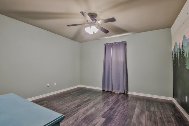 spare room featuring dark hardwood / wood-style flooring and ceiling fan