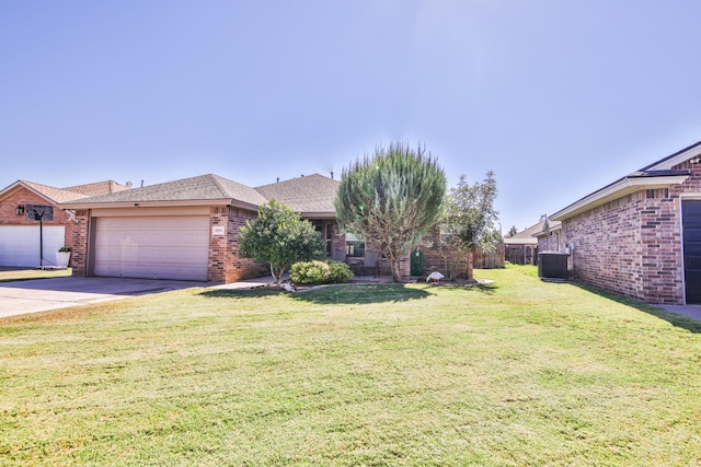 ranch-style home with a garage, central air condition unit, and a front lawn