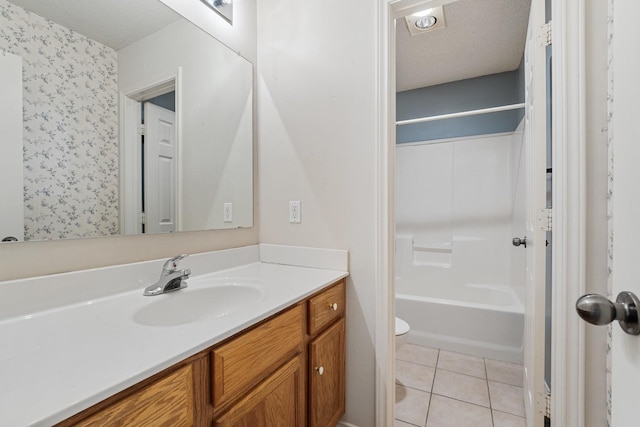 full bathroom featuring tile patterned floors, toilet, a textured ceiling, shower / bathtub combination, and vanity