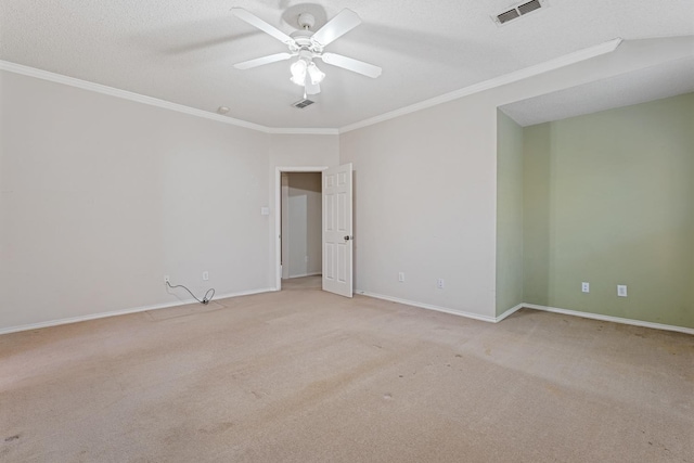 empty room with ornamental molding, light carpet, a textured ceiling, and ceiling fan