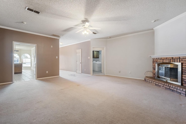 unfurnished living room with crown molding, ceiling fan, a fireplace, and light carpet