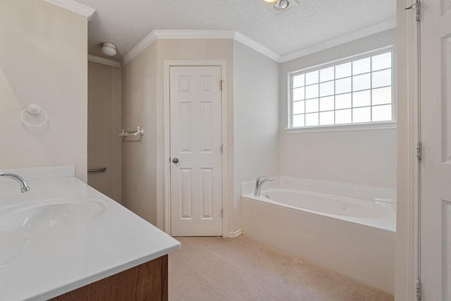 bathroom with vanity, a textured ceiling, ornamental molding, and a bathing tub