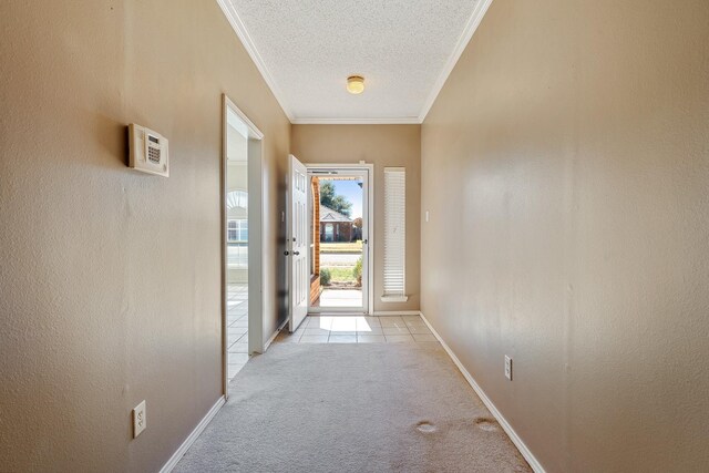 hallway featuring crown molding, light colored carpet, and a textured ceiling