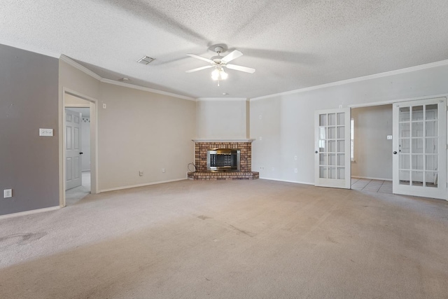 unfurnished living room with a fireplace, ceiling fan, crown molding, light carpet, and french doors