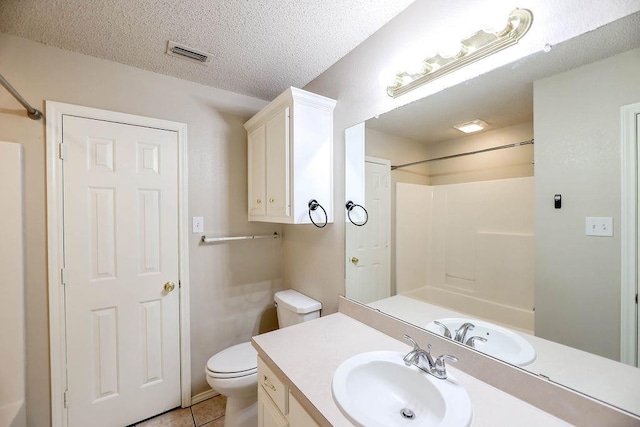 bathroom featuring walk in shower, tile patterned floors, toilet, a textured ceiling, and vanity