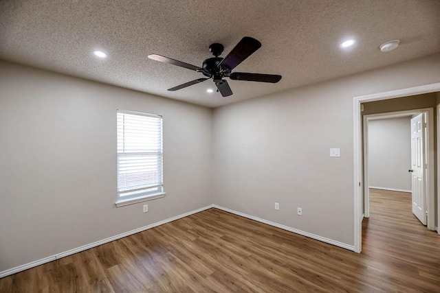 spare room with hardwood / wood-style floors, a textured ceiling, and ceiling fan