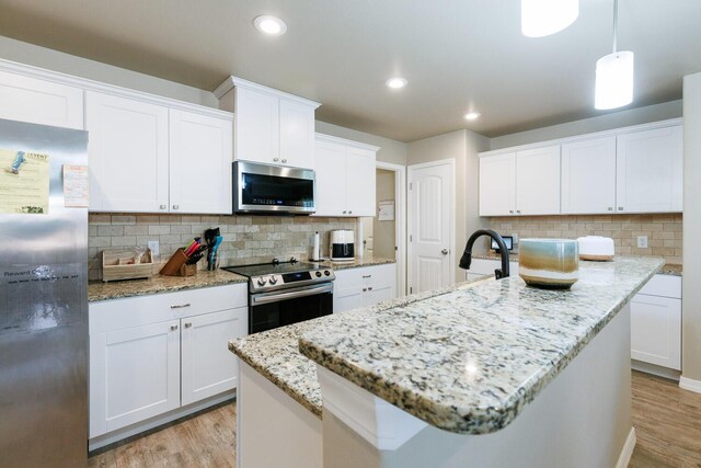 8812 16th St, Lubbock, TX 79416 - kitchen featuring stainless steel appliances, light wood-style flooring, and tasteful backsplash