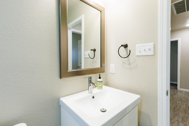 8812 16th St, Lubbock, TX 79416 - bathroom featuring vanity, wood finished floors, and visible vents