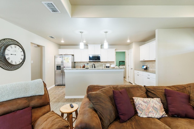 8812 16th St, Lubbock, TX 79416 - living area featuring recessed lighting, baseboards, light wood-type flooring, and visible vents
