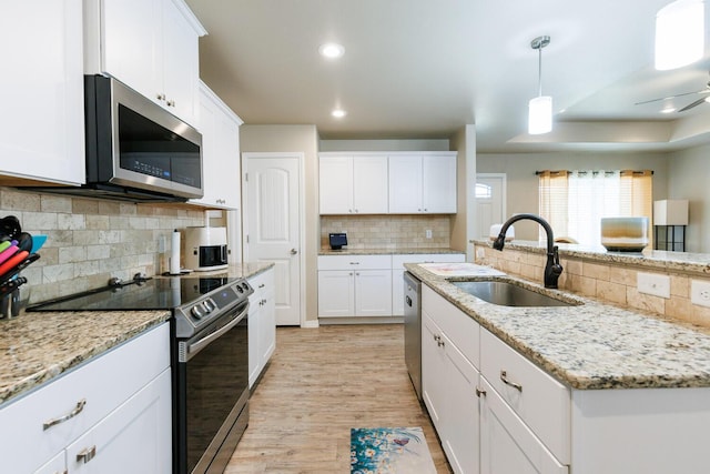 8812 16th St, Lubbock, TX 79416 - kitchen with a sink, decorative backsplash, appliances with stainless steel finishes, and white cabinets