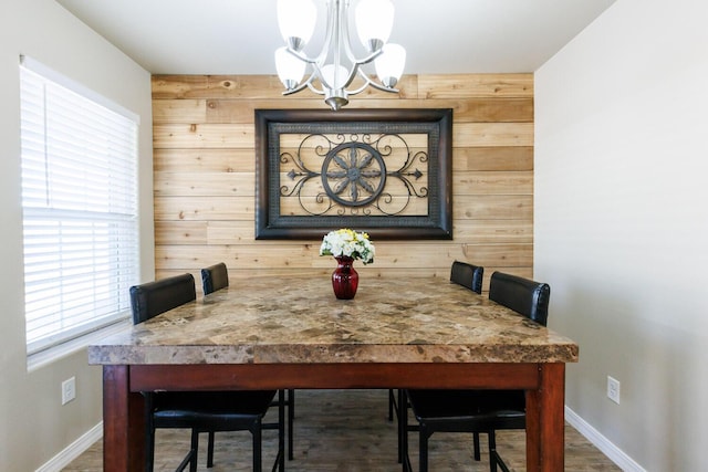 8812 16th St, Lubbock, TX 79416 - dining space with baseboards, a chandelier, and wood finished floors