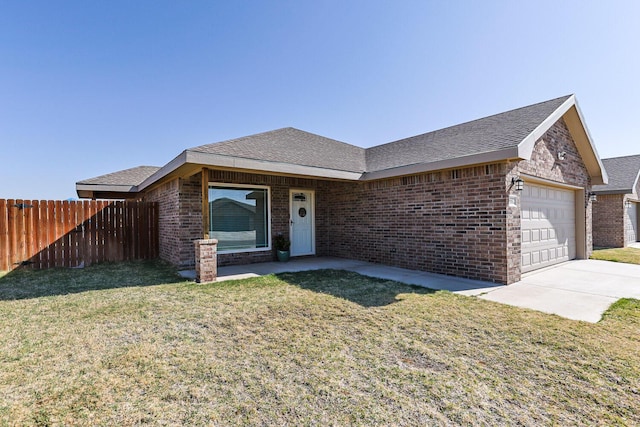8812 16th St, Lubbock, TX 79416 - ranch-style house featuring fence, a garage, a front yard, and brick siding