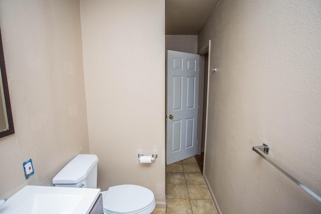 bathroom with vanity, toilet, and tile patterned flooring