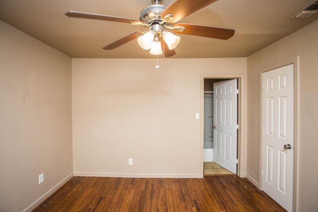 spare room with ceiling fan and dark hardwood / wood-style flooring