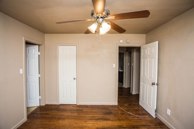 unfurnished bedroom featuring dark hardwood / wood-style floors and ceiling fan