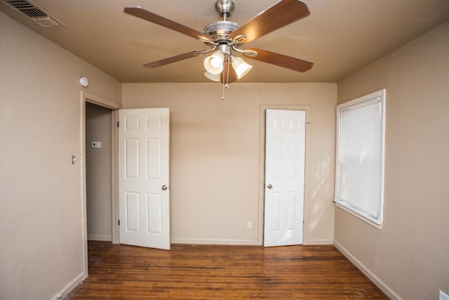 unfurnished bedroom with dark wood-type flooring and ceiling fan