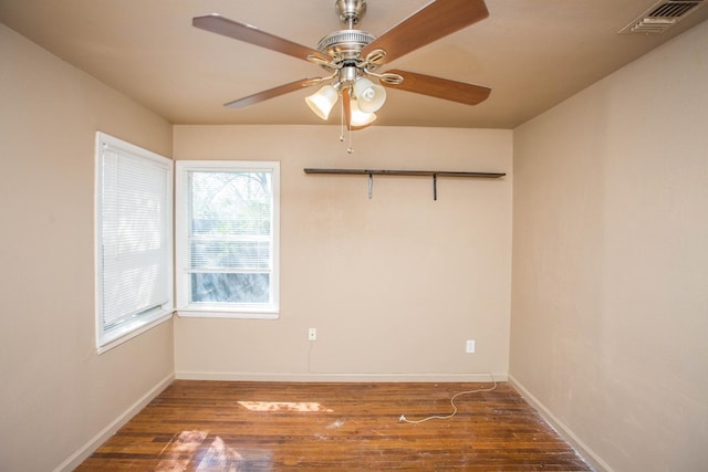 spare room with dark hardwood / wood-style floors and ceiling fan