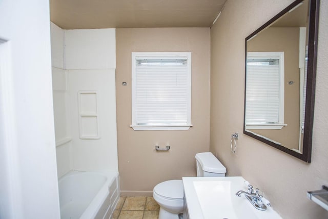 bathroom featuring sink, tile patterned floors, toilet, and a bathtub