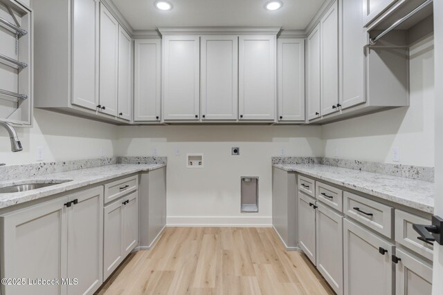 7726 46th St, Lubbock, TX 79407 - laundry area with light wood-style floors, electric dryer hookup, hookup for a washing machine, cabinet space, and recessed lighting