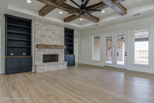 7726 46th St, Lubbock, TX 79407 - unfurnished living room featuring coffered ceiling, a ceiling fan, light wood-style flooring, built in features, and a fireplace