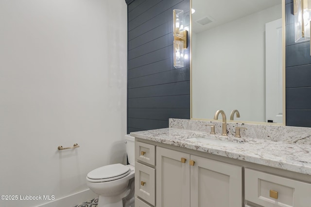 7726 46th St, Lubbock, TX 79407 - half bathroom with vanity and wood walls