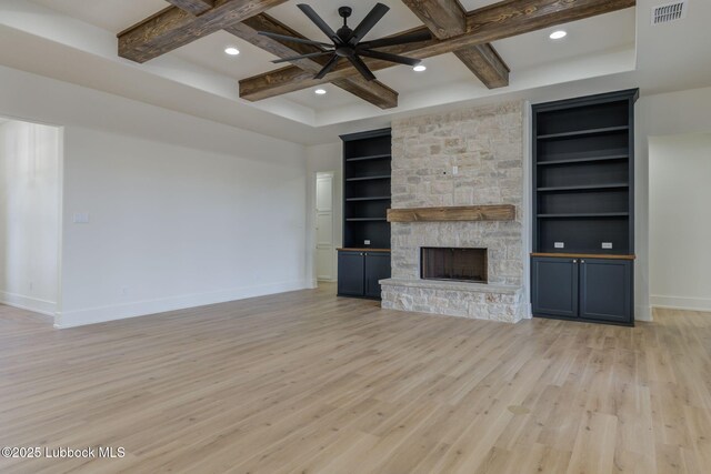 7726 46th St, Lubbock, TX 79407 - unfurnished living room with ceiling fan, built in features, light wood-style floors, coffered ceiling, and a stone fireplace