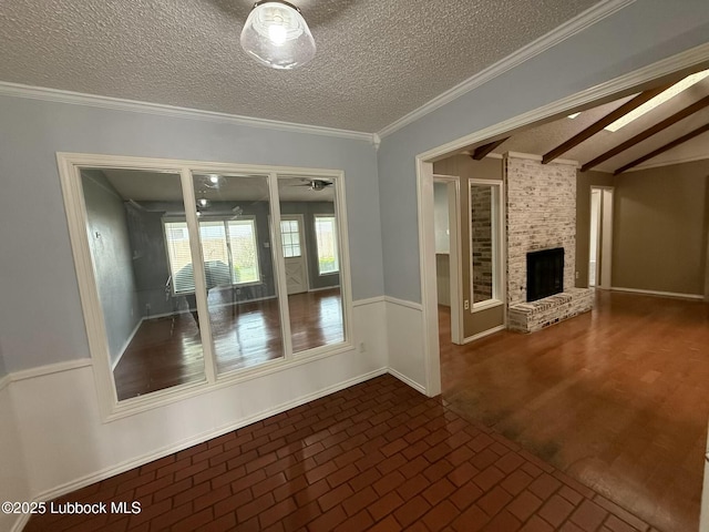 3506 97th St, Lubbock, TX 79423 - unfurnished living room featuring brick patterned flooring, a brick fireplace, a textured ceiling, wainscoting, and ornamental molding
