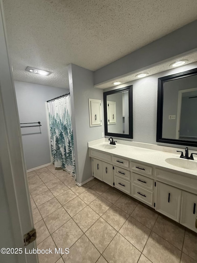 3506 97th St, Lubbock, TX 79423 - full bath featuring double vanity, tile patterned floors, a textured ceiling, and baseboards