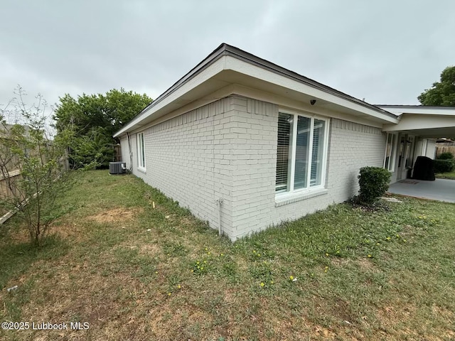 3506 97th St, Lubbock, TX 79423 - view of home's exterior featuring brick siding, central AC unit, and a patio