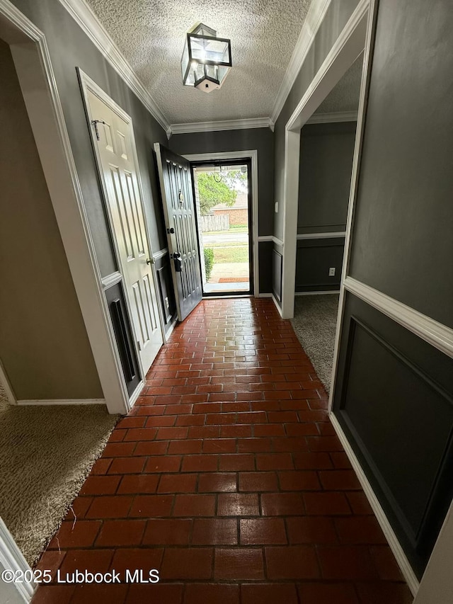3506 97th St, Lubbock, TX 79423 - hall with brick floors, a textured ceiling, crown molding, and baseboards